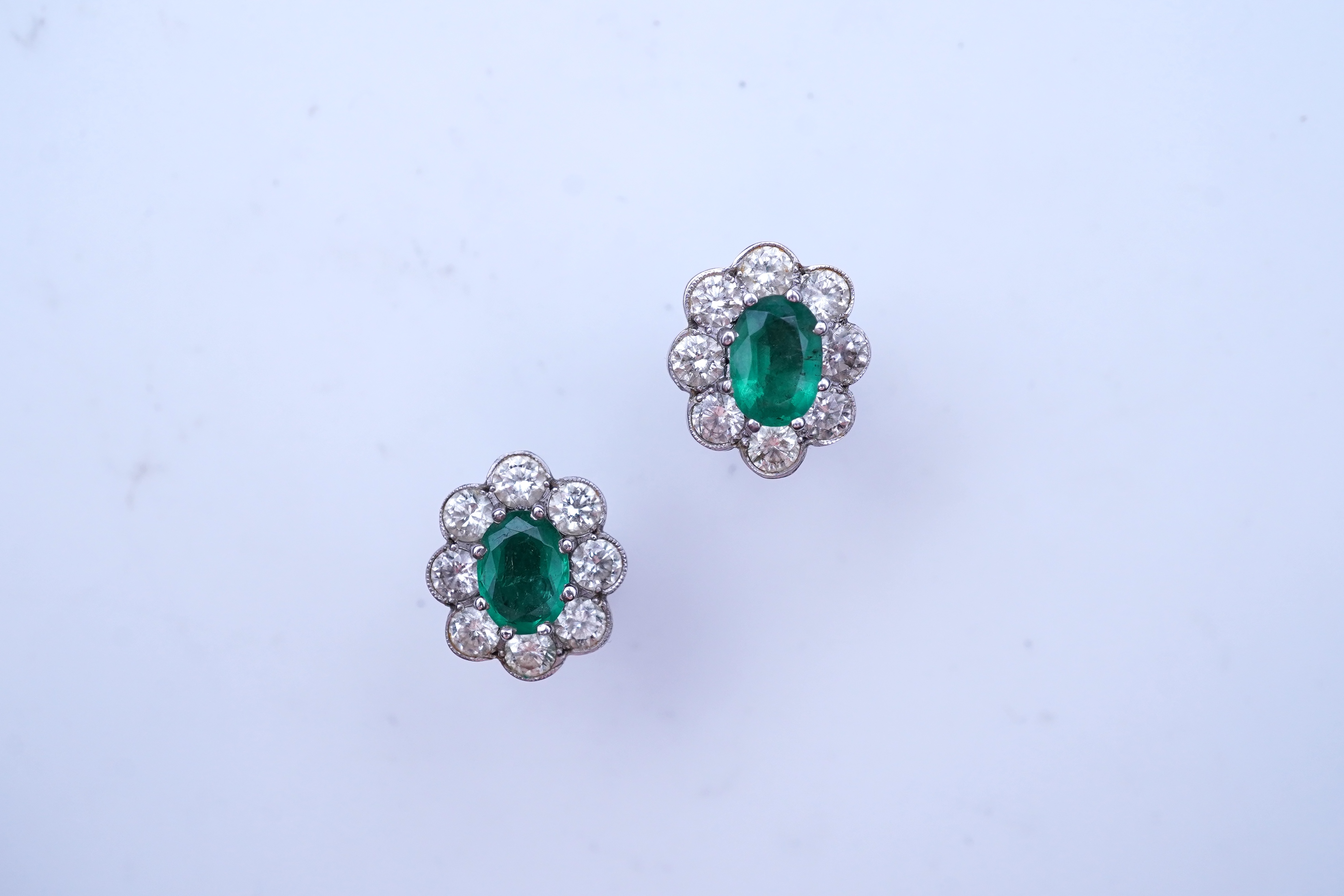 A pair of emerald and diamond earrings